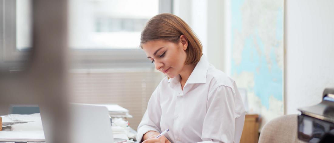 young female administrator working at a desk