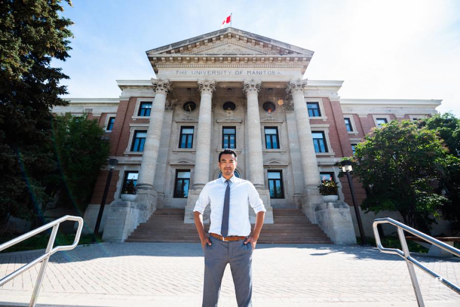 apllied business analysis student standing in front of UManitoba Admin building