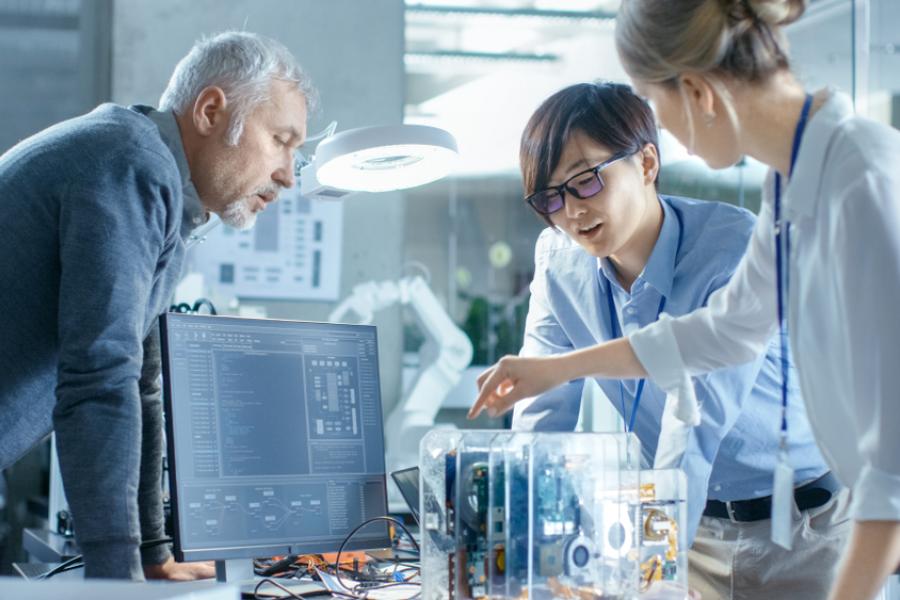 team of technicians supervise and inspect circuit manufacture