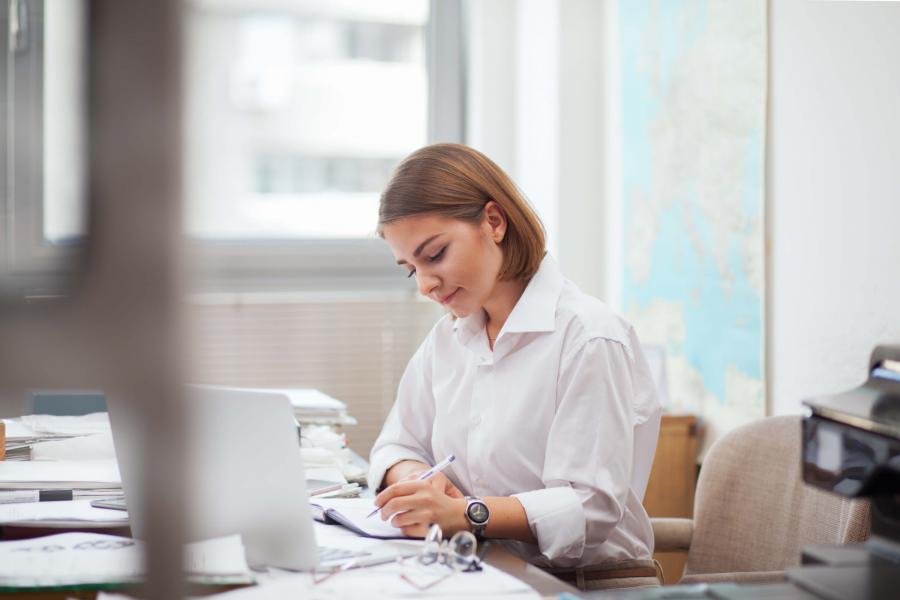 young female administrator working at a desk