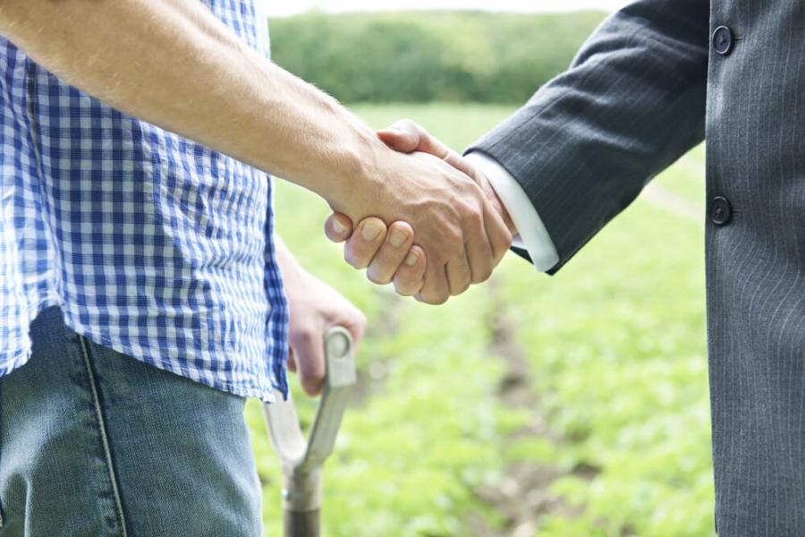 Handshake between farmer and businessman