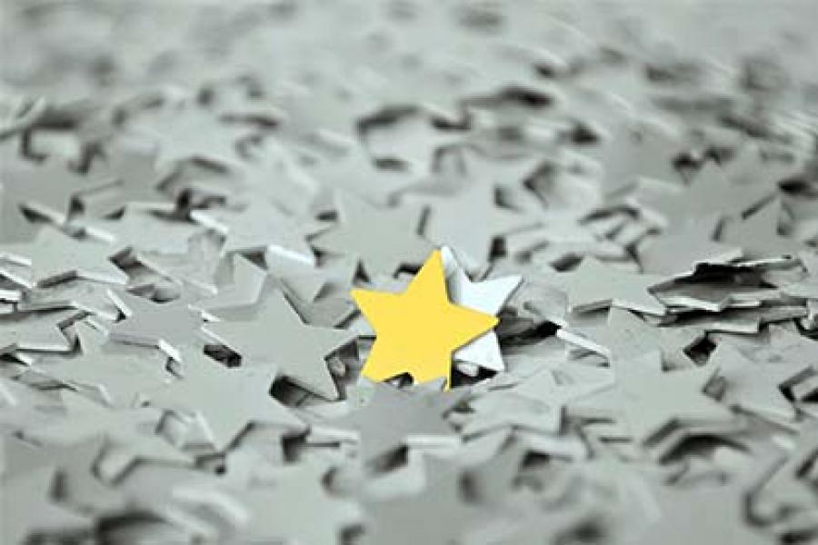 The yellow star is in the middle of the grey and white stars.
