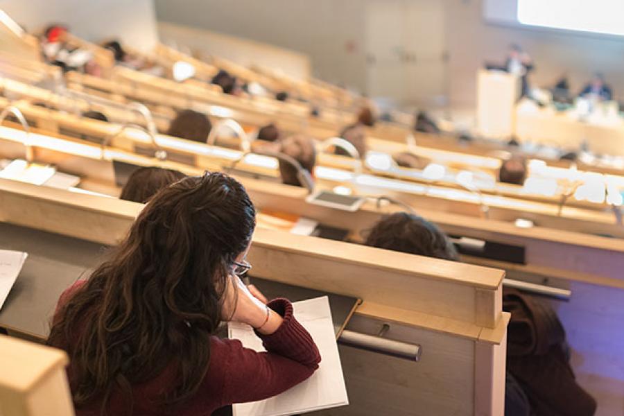 Students are taking notes in the lecture hall.