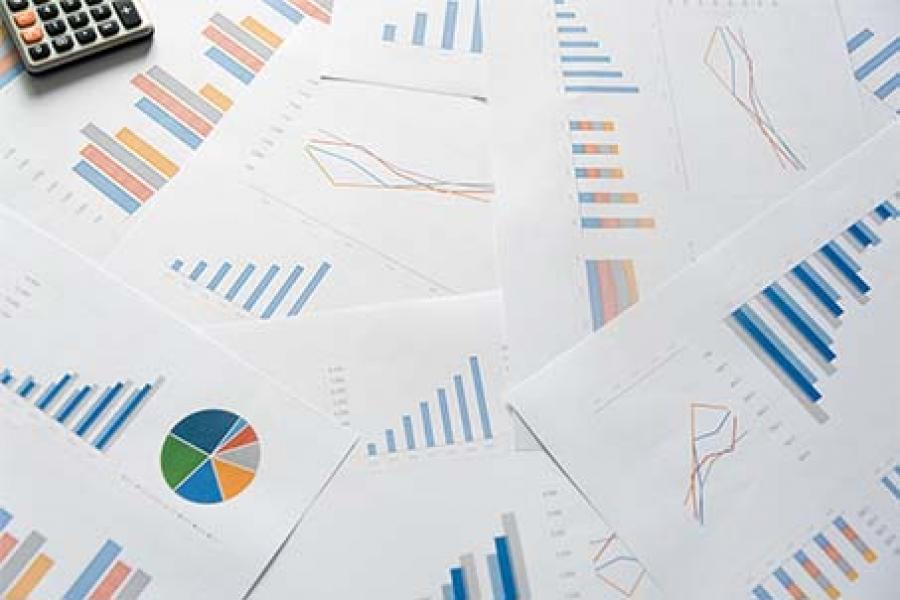 The calculator and analytics graphs documents are on the table.