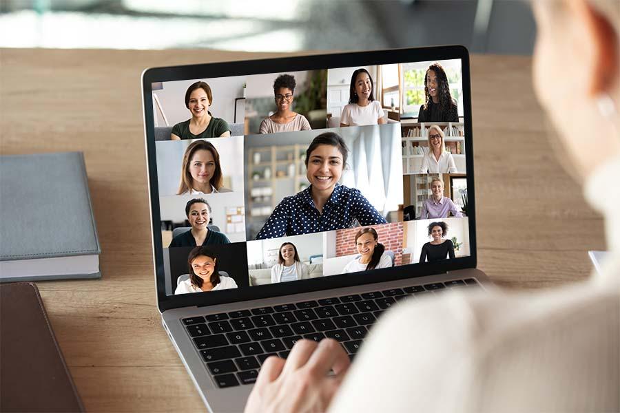 The woman is using her laptop to join a virtual meeting.