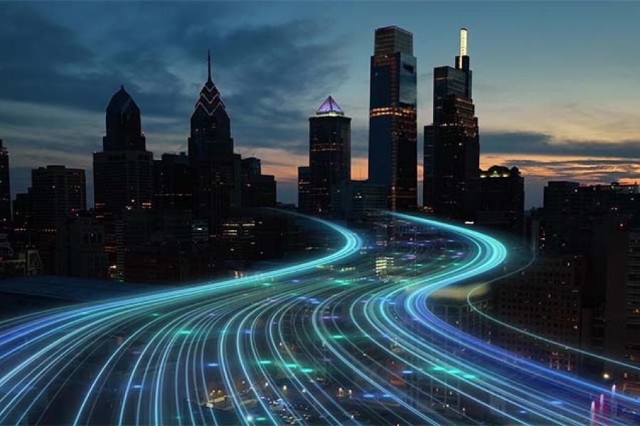 City skyline with glowing digital lines representing high-speed data flow at dusk, showcasing urban technology and connectivity advancements.