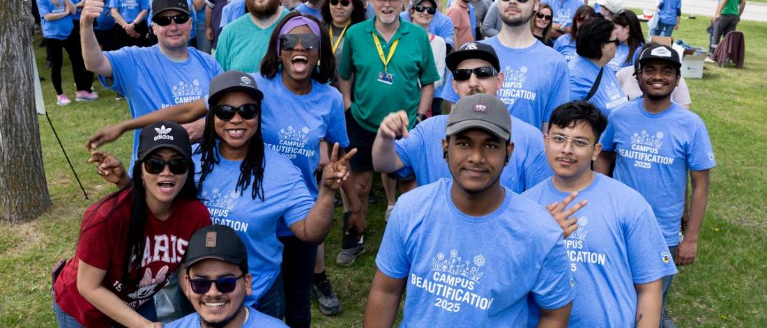 large group of Fort Garry Volunteers for Campus beautification day collect for a group picture