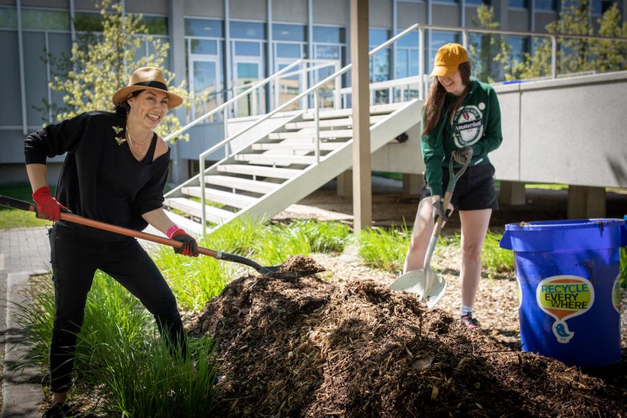 2 women digging in the dirt.