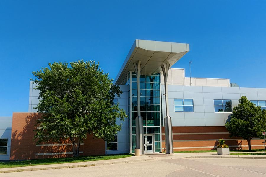 Large building next to a large green bush located at 196 Innovation Drive.