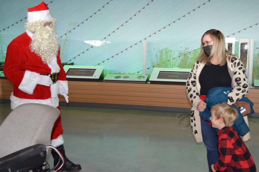 A young child is thrilled to meet Santa during FFDC's Santa on the Farm event.