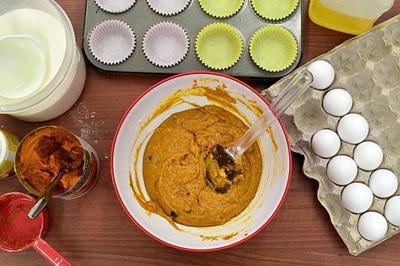 Ingredients are displayed around a bowl of batter