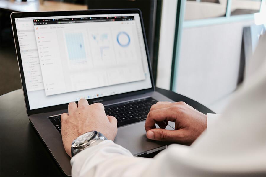 A person's hands typing on a computer.