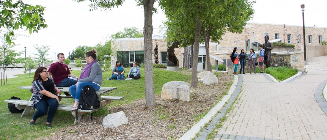 students gathered outside of migizii agamik on fort garry campus
