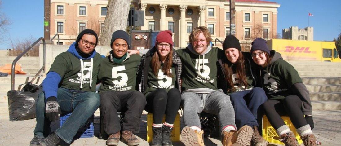 students sitting outside the main administrative building in support of 5 days for the homeless