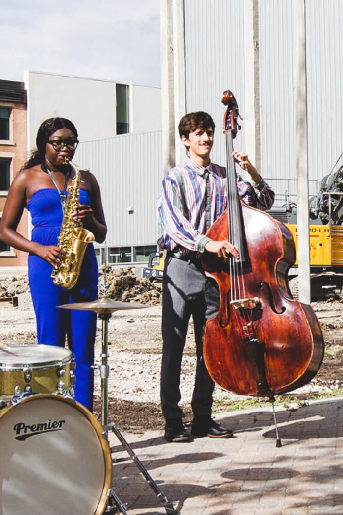 Desautels faculty of music students Josh Bonneteau (drums), Joyce German (saxophone) and Sam Fournier (bass) perform on the future concert hall site.