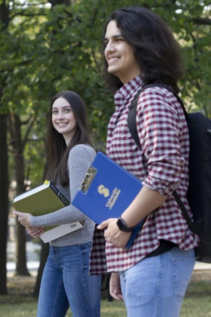 Students walking outside in summer.