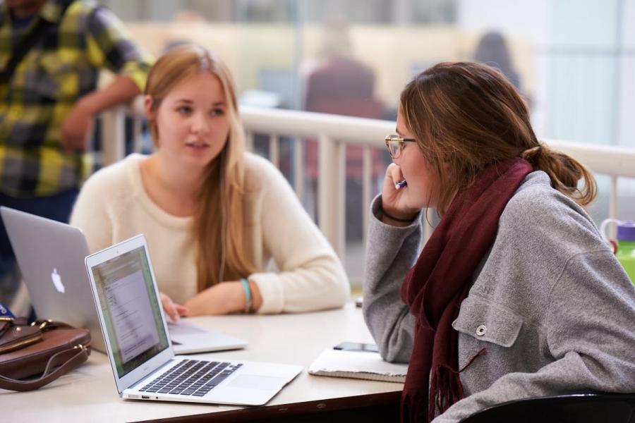 Two female students studying at a table.