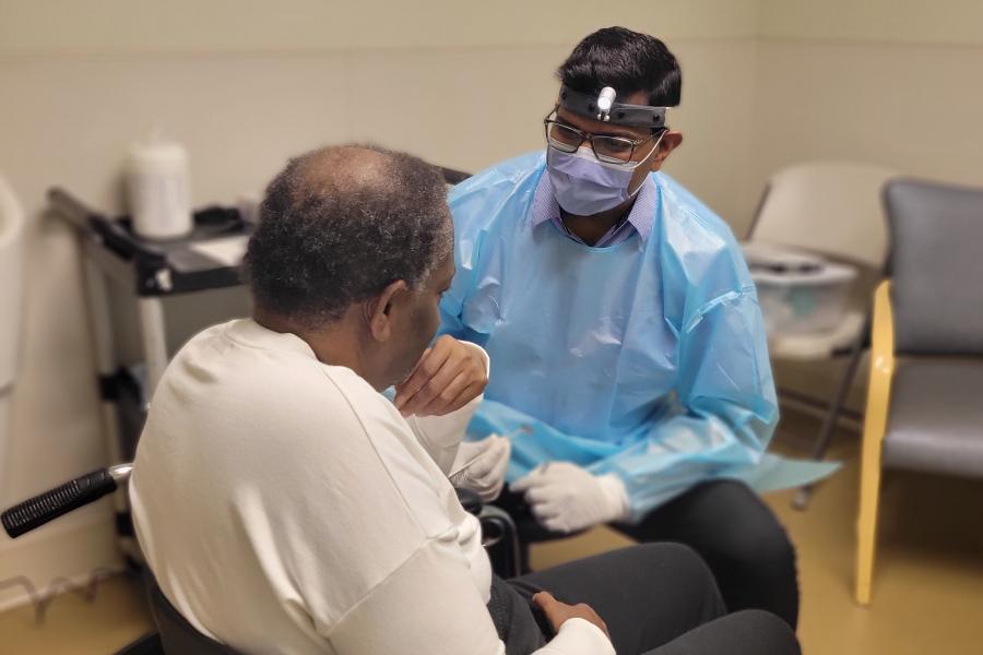 Dentist helping patient.