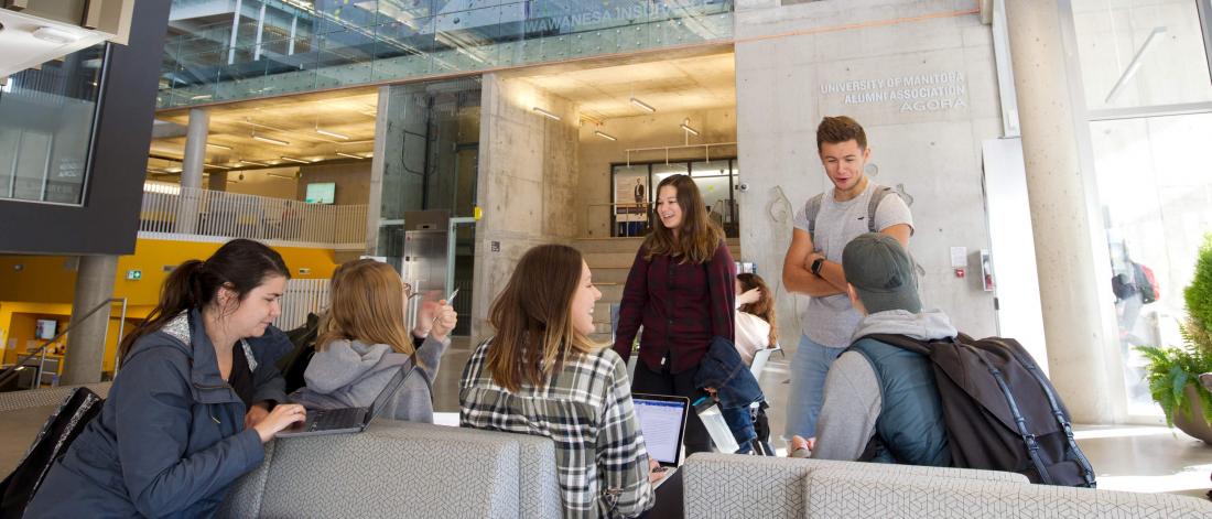 A group of seven students hanging out and studying together inside the Active Living Centre.