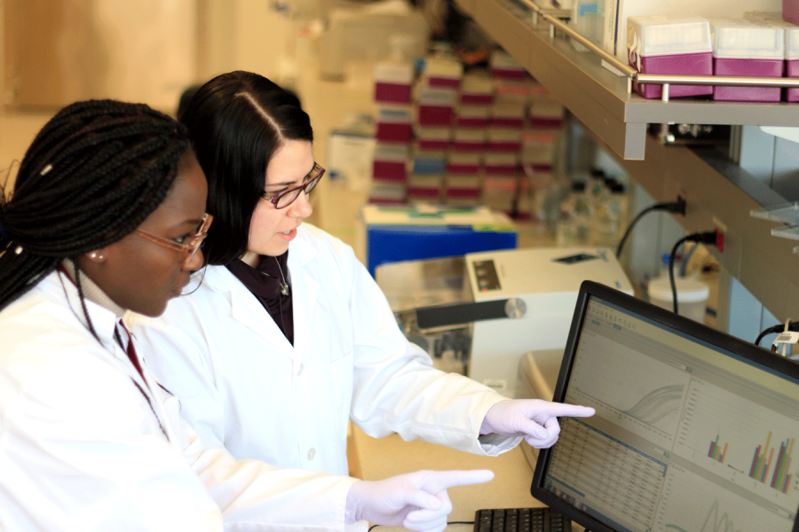 Two students examine data on a computer in the Marshall Lab.