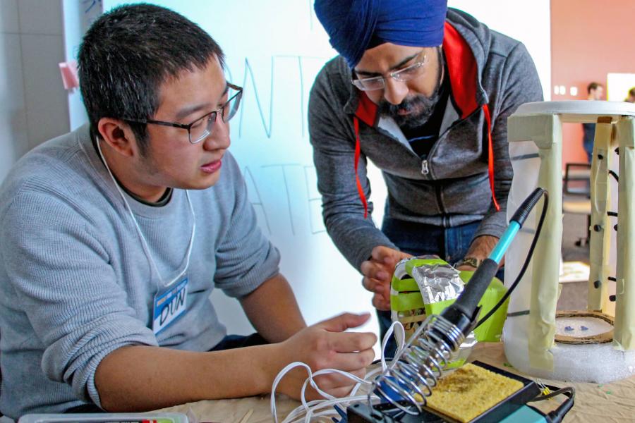 Two students work on a project together during a science competition.