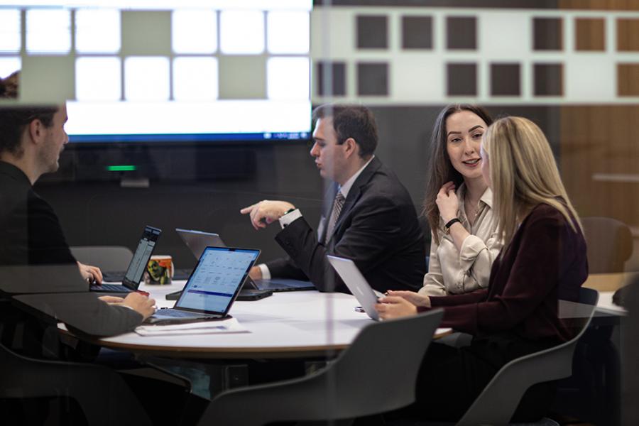 A group of students around a table working.