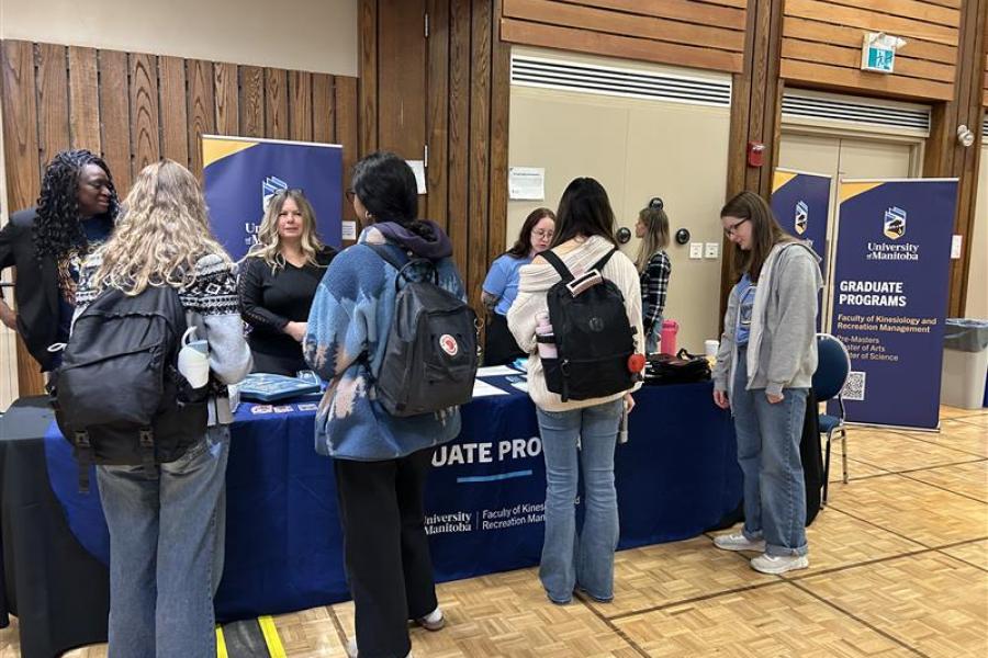 Group of students visiting a booth during open house.