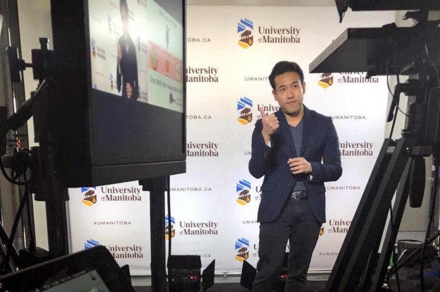 Toby Le giving his 3MT presentation in front of a video camera at the University of Manitoba.