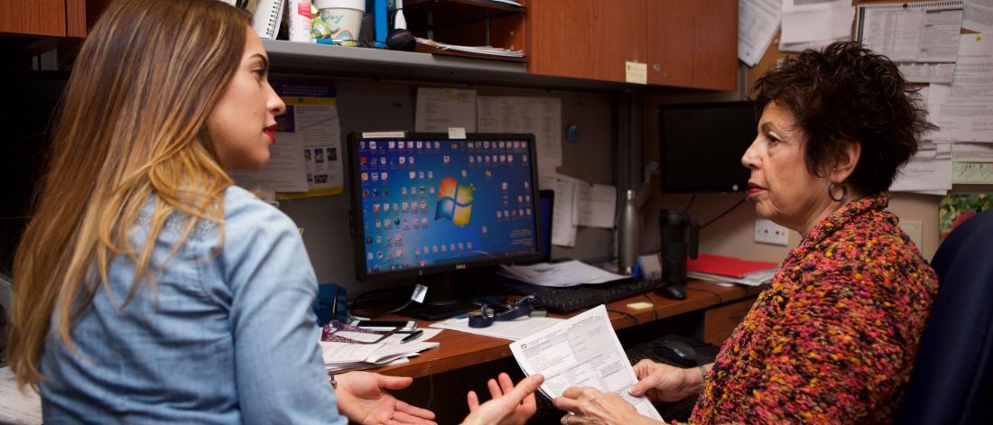 Faculty member teaches student in her office