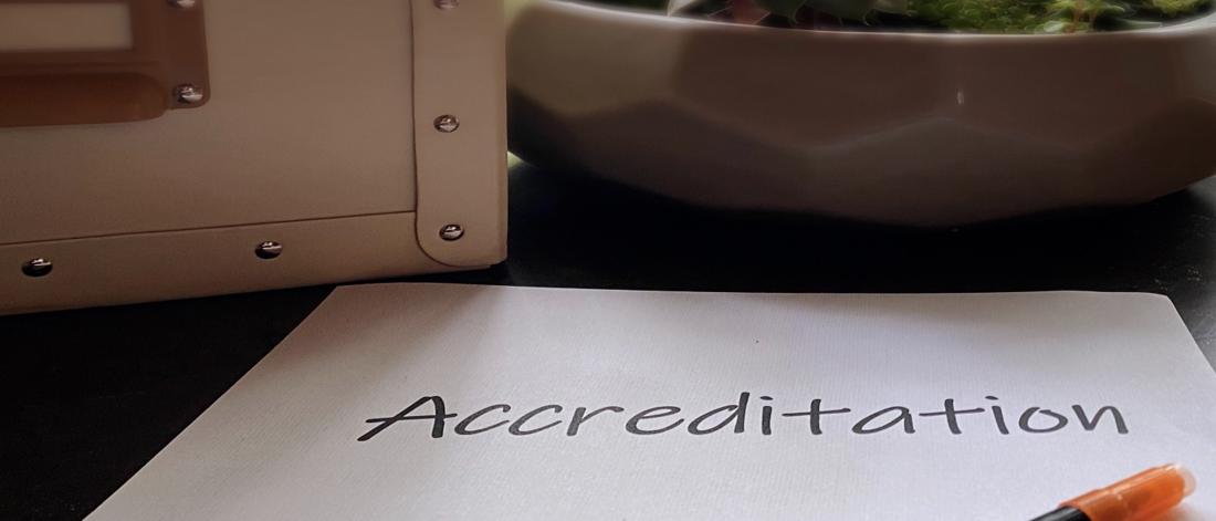 Accreditation written out on a piece of paper.