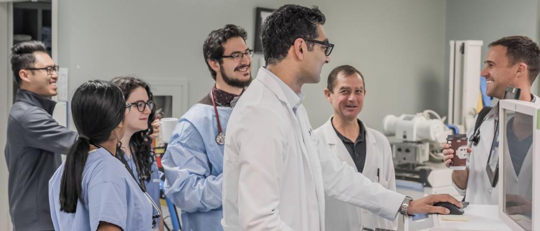 Group of faculty and residents reviewing a computer screen.