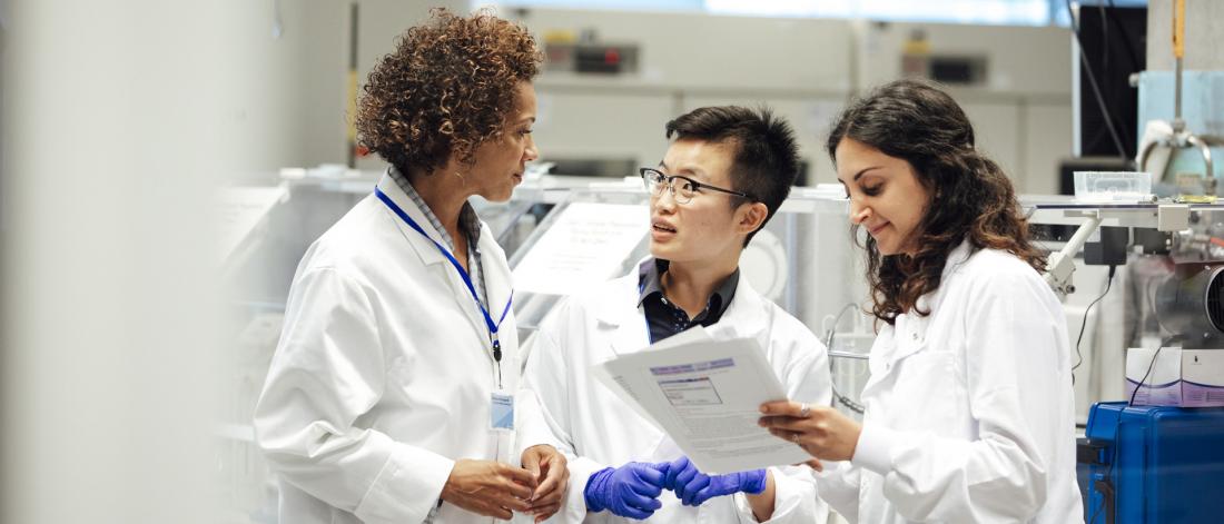 A group of women scientists talking.