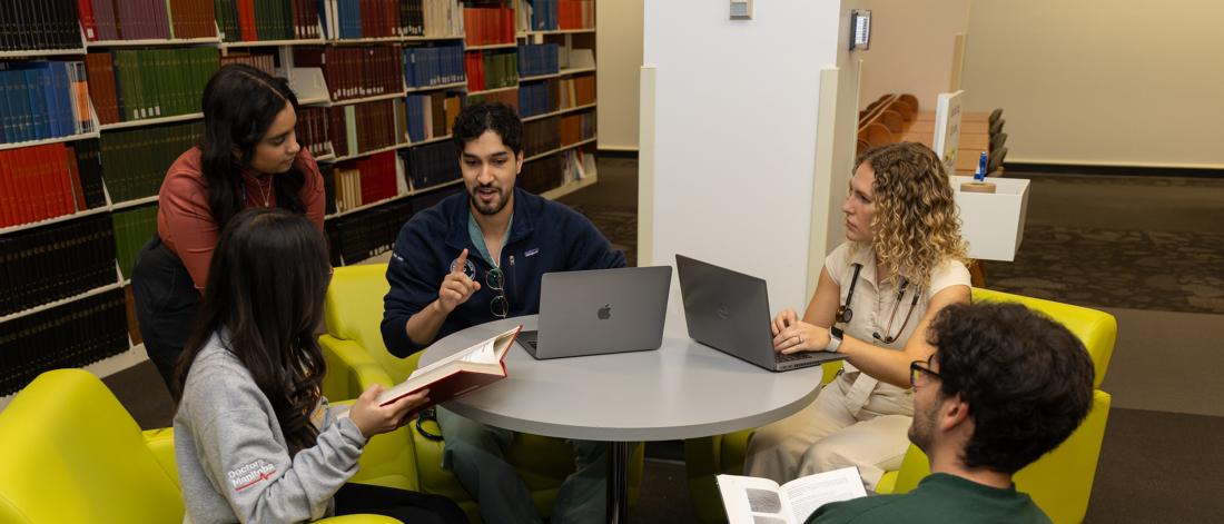 A group of students sitting at a table.