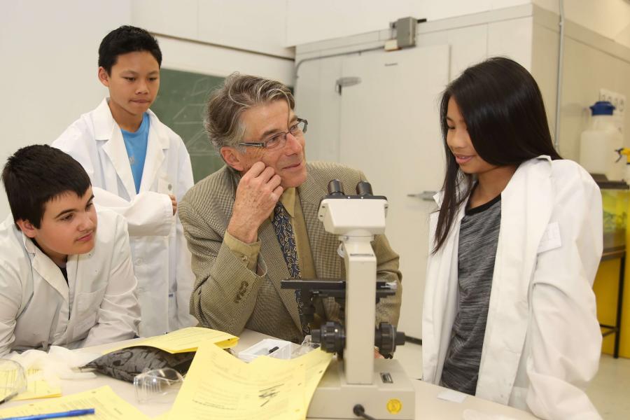 Dr. James Gilchrist talking with students in a lab.