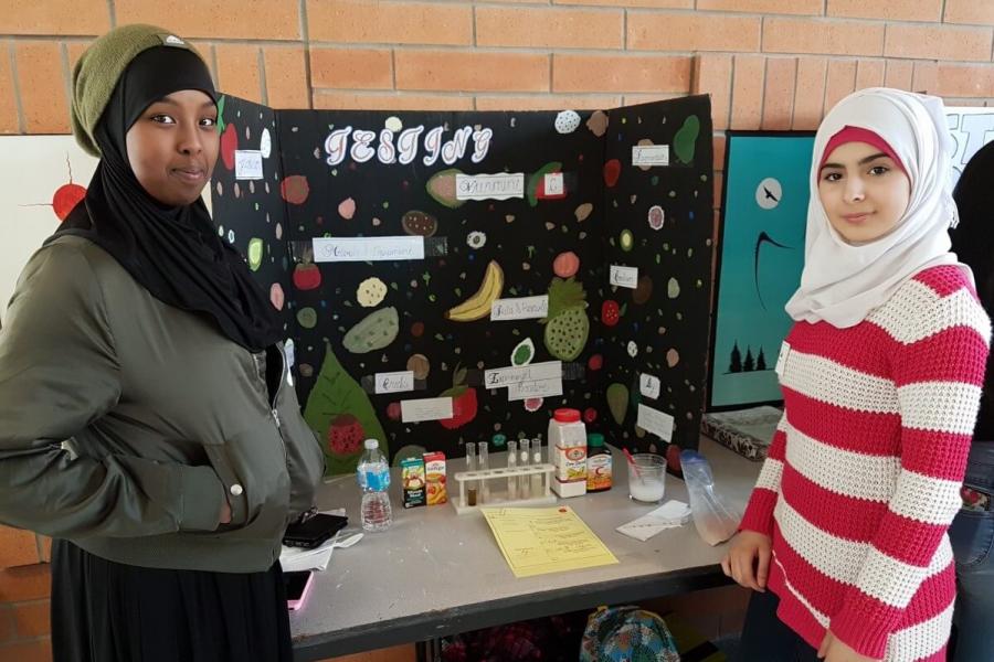 Proud students display their science fair project.