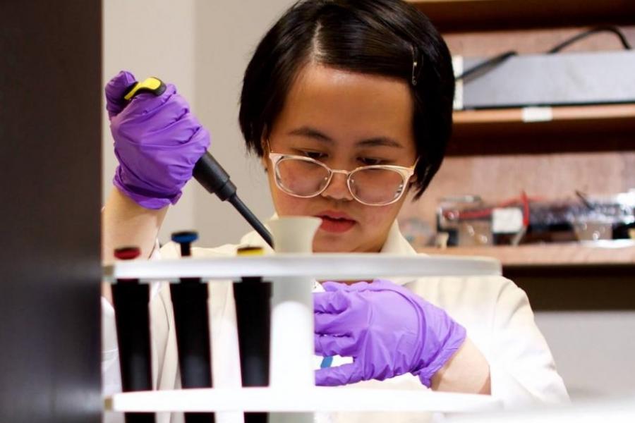 Student working with a test-tube.