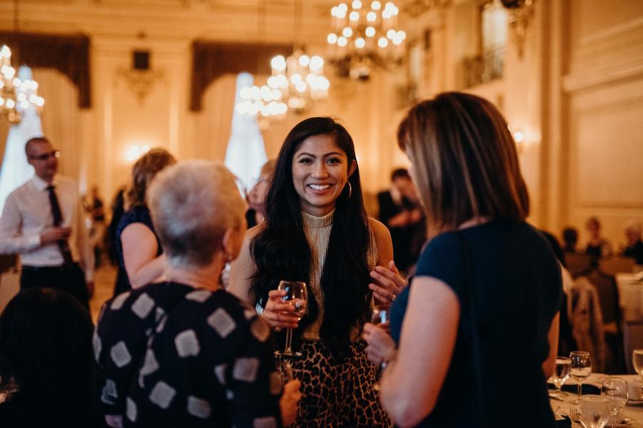 a group of dentistry alumni having a conversation at an Alumni awards event.