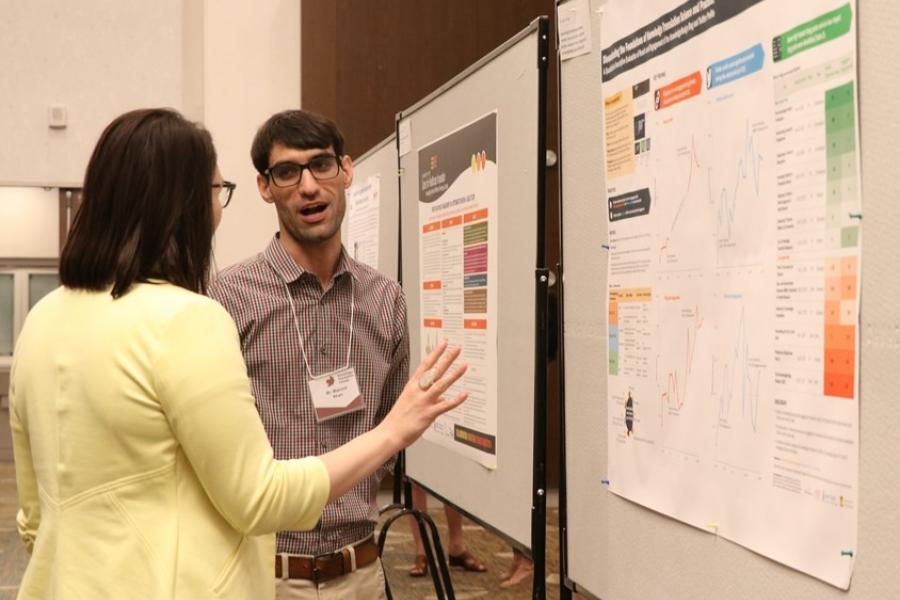 Two researchers looking at a poster.