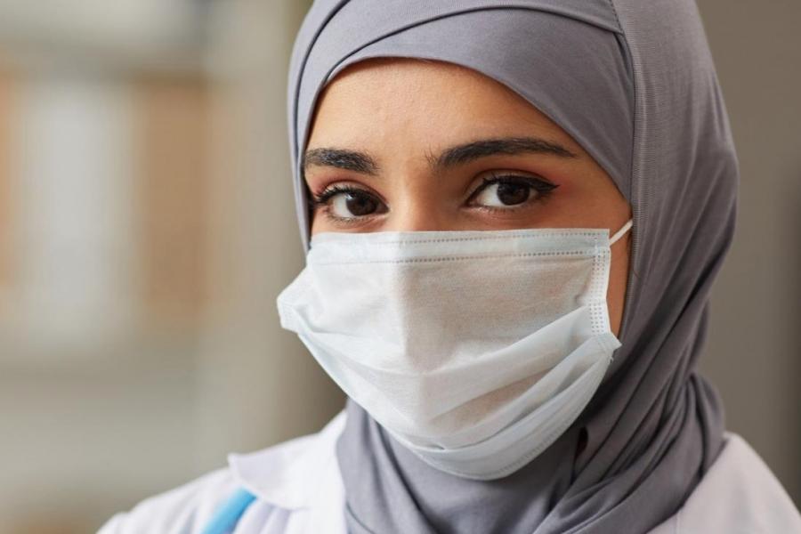 Physician in a mask and hijab.