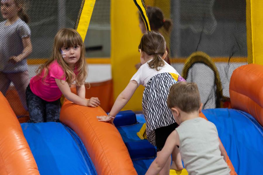 Children playing on a bounc house at a community event hosted by the Rady Faculty.