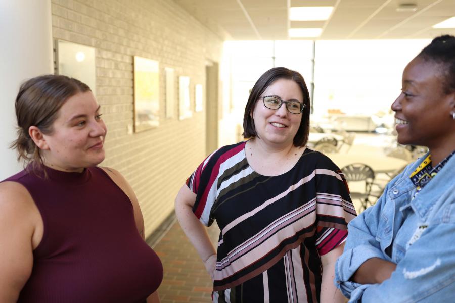 A group of people smiling and chatting.
