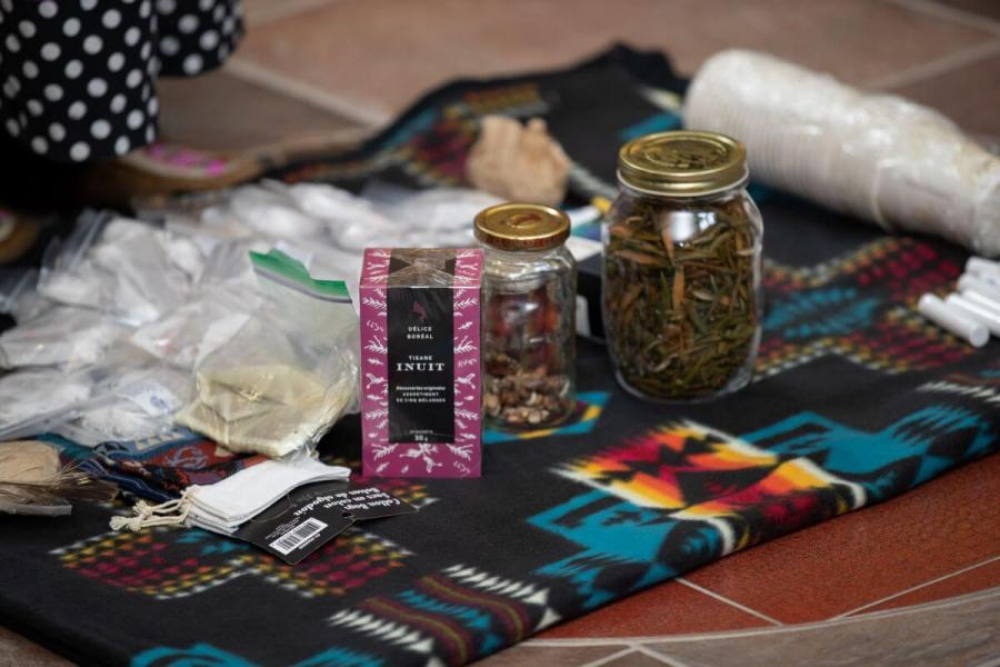 Various Indigenous medicine on a blanket laid out on the floor