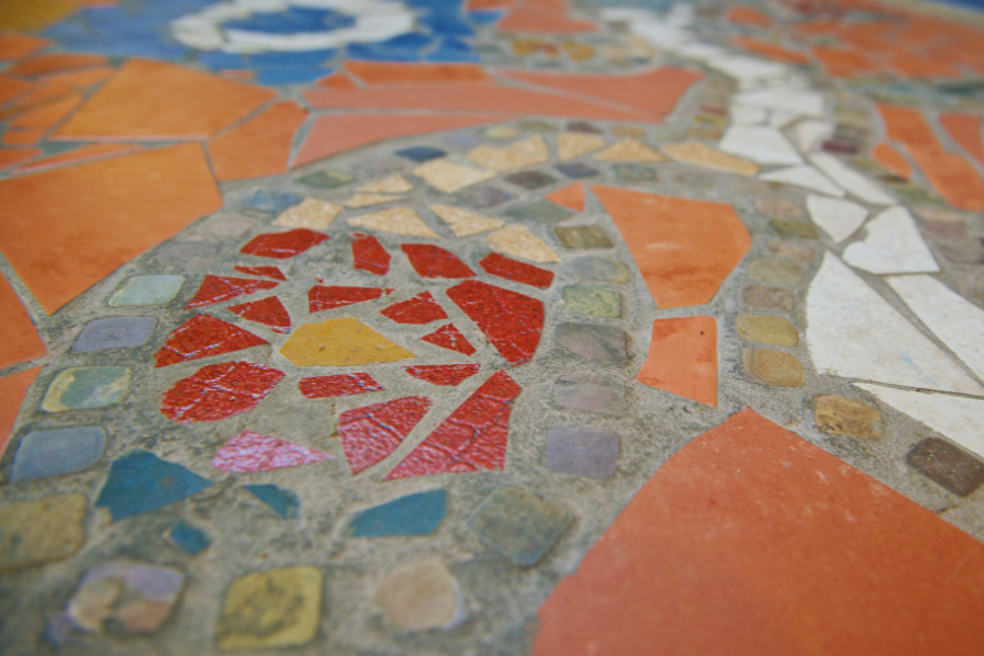 Indigenous mosaic artwork on the floor inside a campus building.