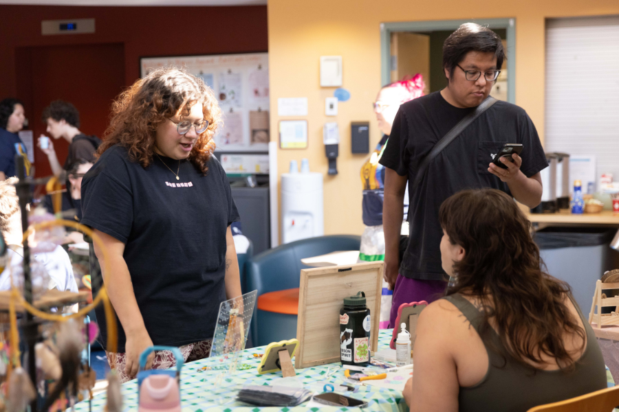 Students visiting an information table at the Indigenous Student Centre.