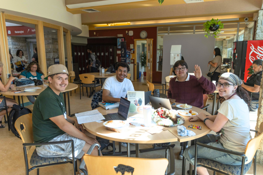 Students gathered around a table in the Indigenous Student Centre.