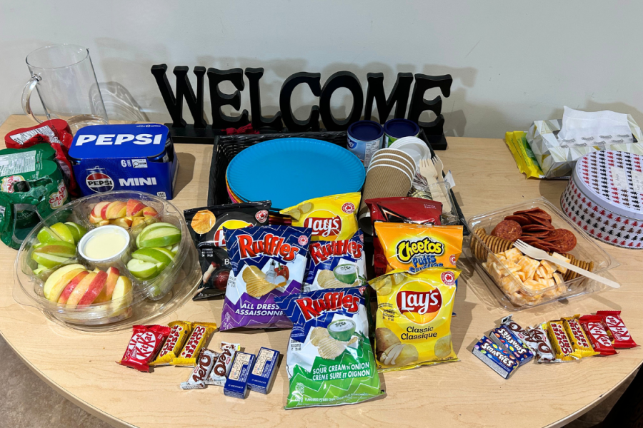 Refreshments and snacks arranged on a table for a program gathering.