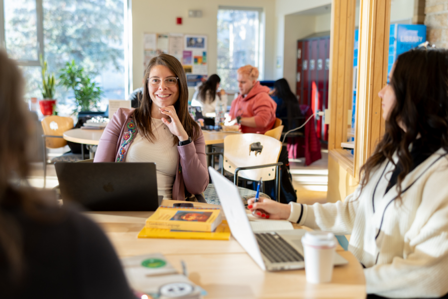 Students participating in a discussion while working together at a table.