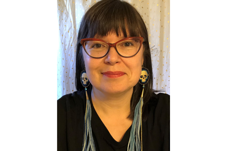 Headshot of Marsha, wearing glasses and long earrings, smiling at the camera.