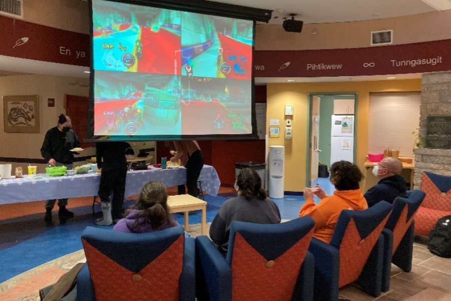 Students play a video game during a Neechiwaken gathering.