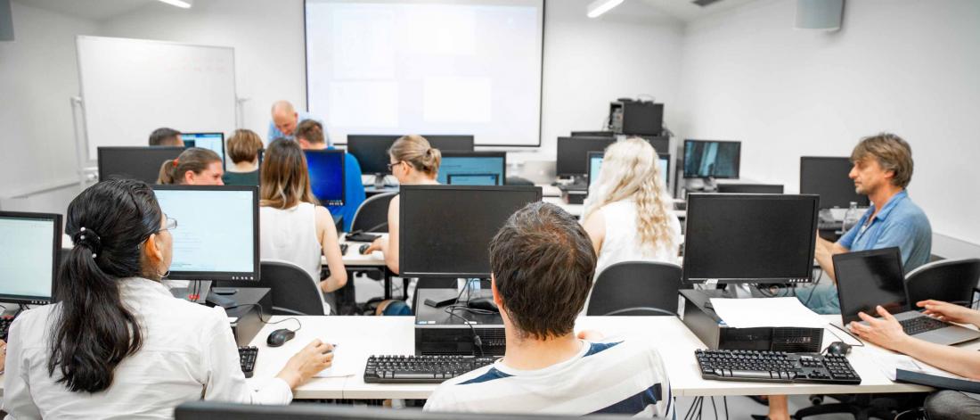 students in classroom with monitors